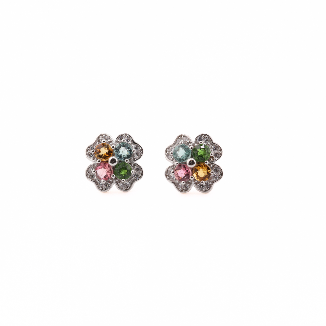 Pair of flower-shaped earrings with Tourmaline gemstones on a white background