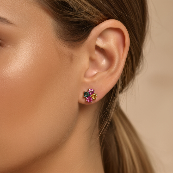 Close-up of an ear wearing a Tourmaline earring against a neutral background
