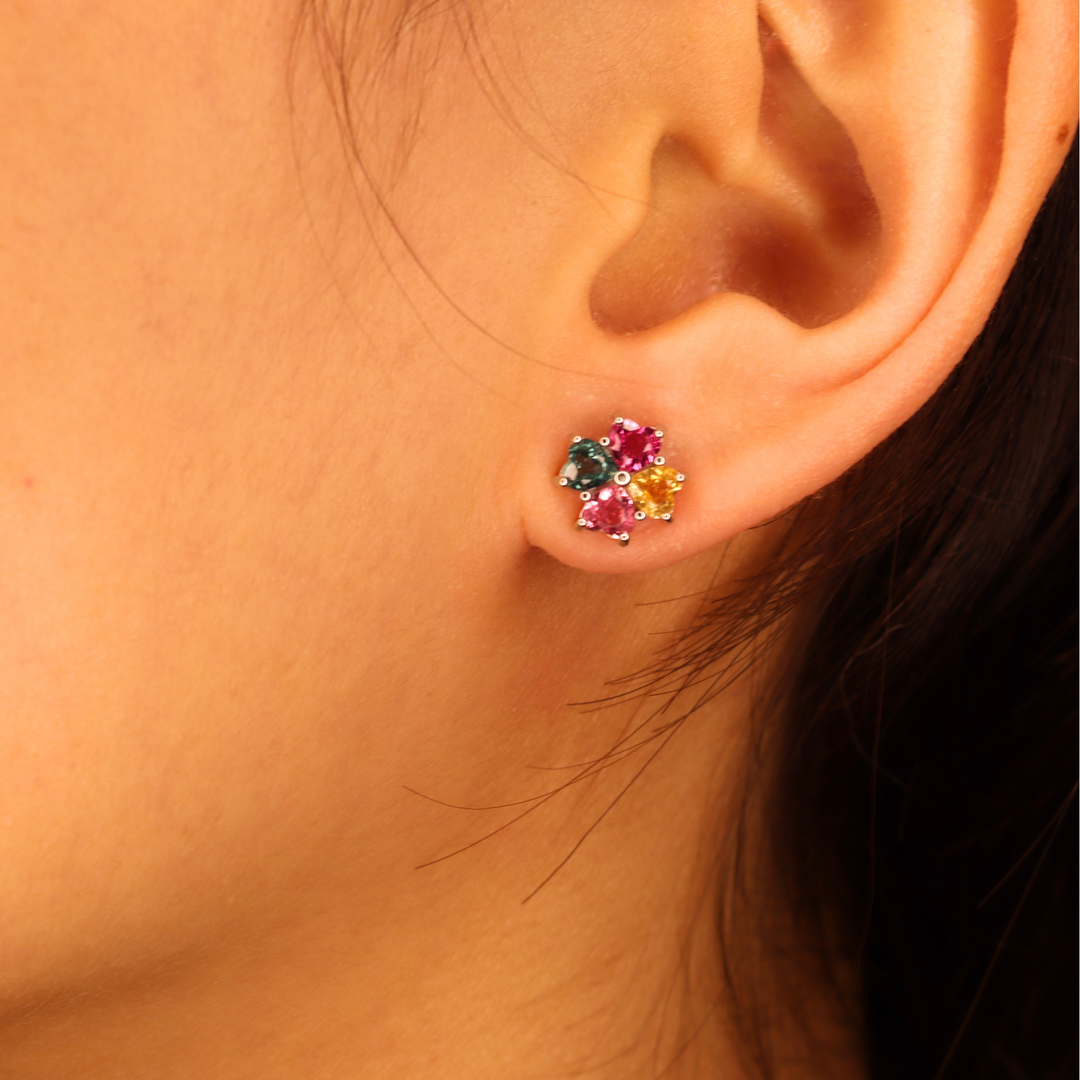 Close-up of an ear wearing a Tourmaline gemstone earring.